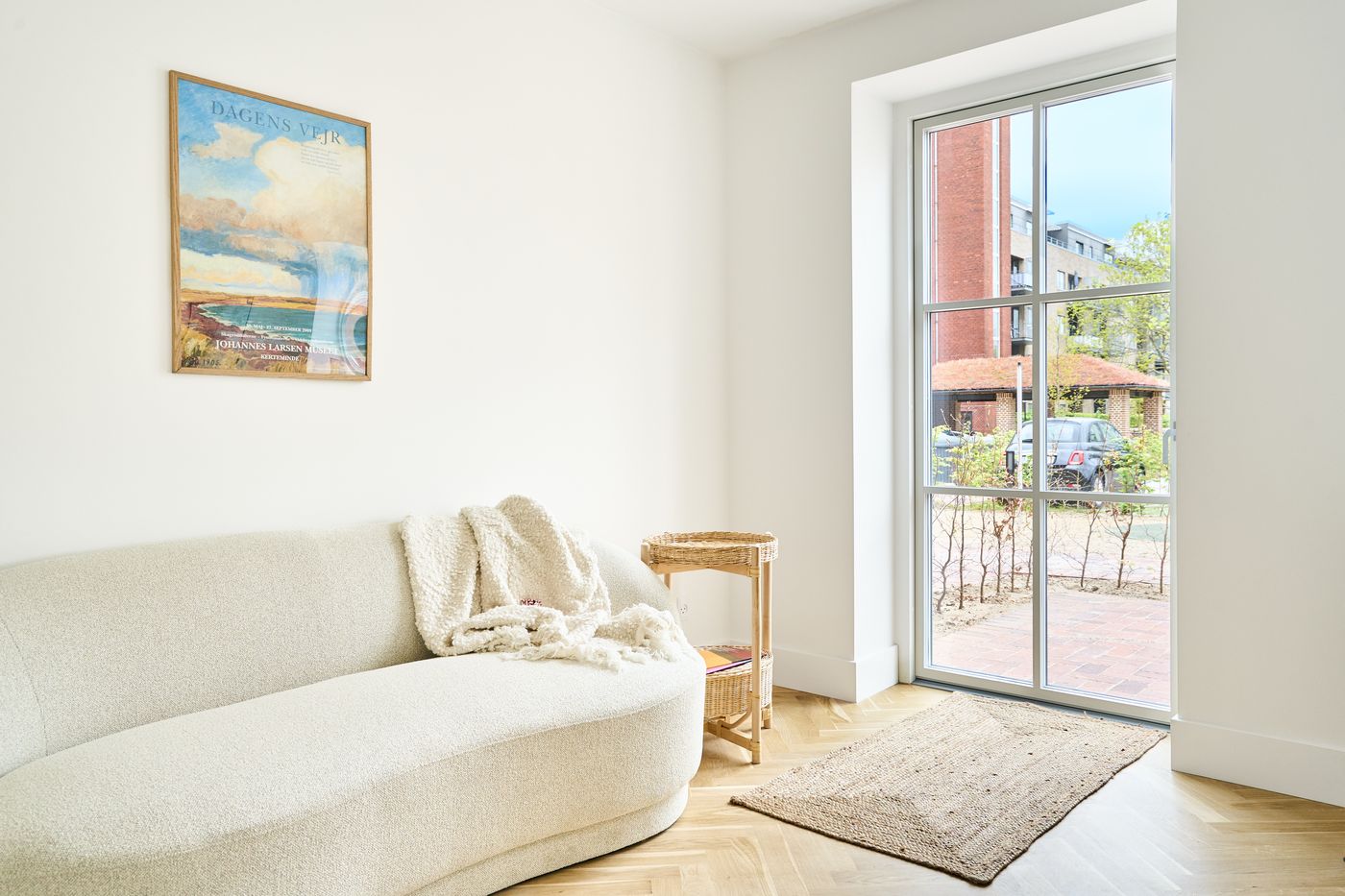 Furnished living room with balcony access in an Odense apartment